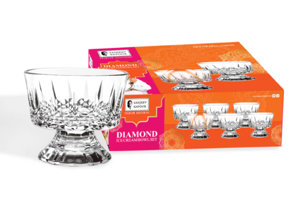 Clear glass bowl in front of an orange box packaging on a white background
