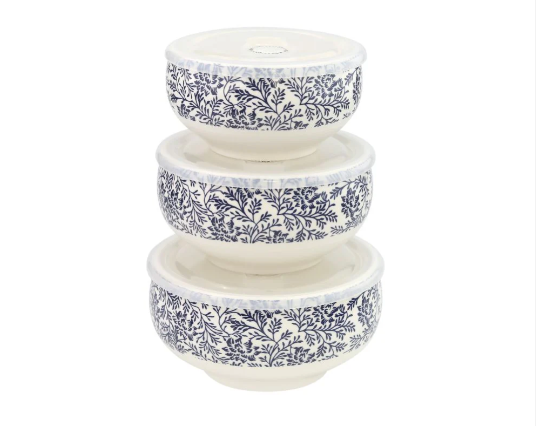 Set of three ceramic bowls with blue floral patterns on a white background